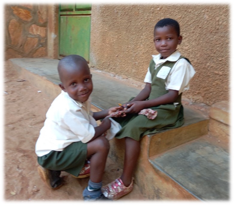 Image showing two children outside the classrooms at Kiyindi, Uganda